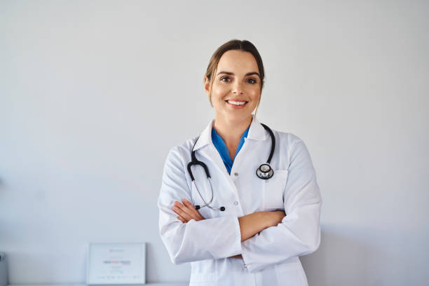 Portrait of smiling female doctor wearing uniform standing